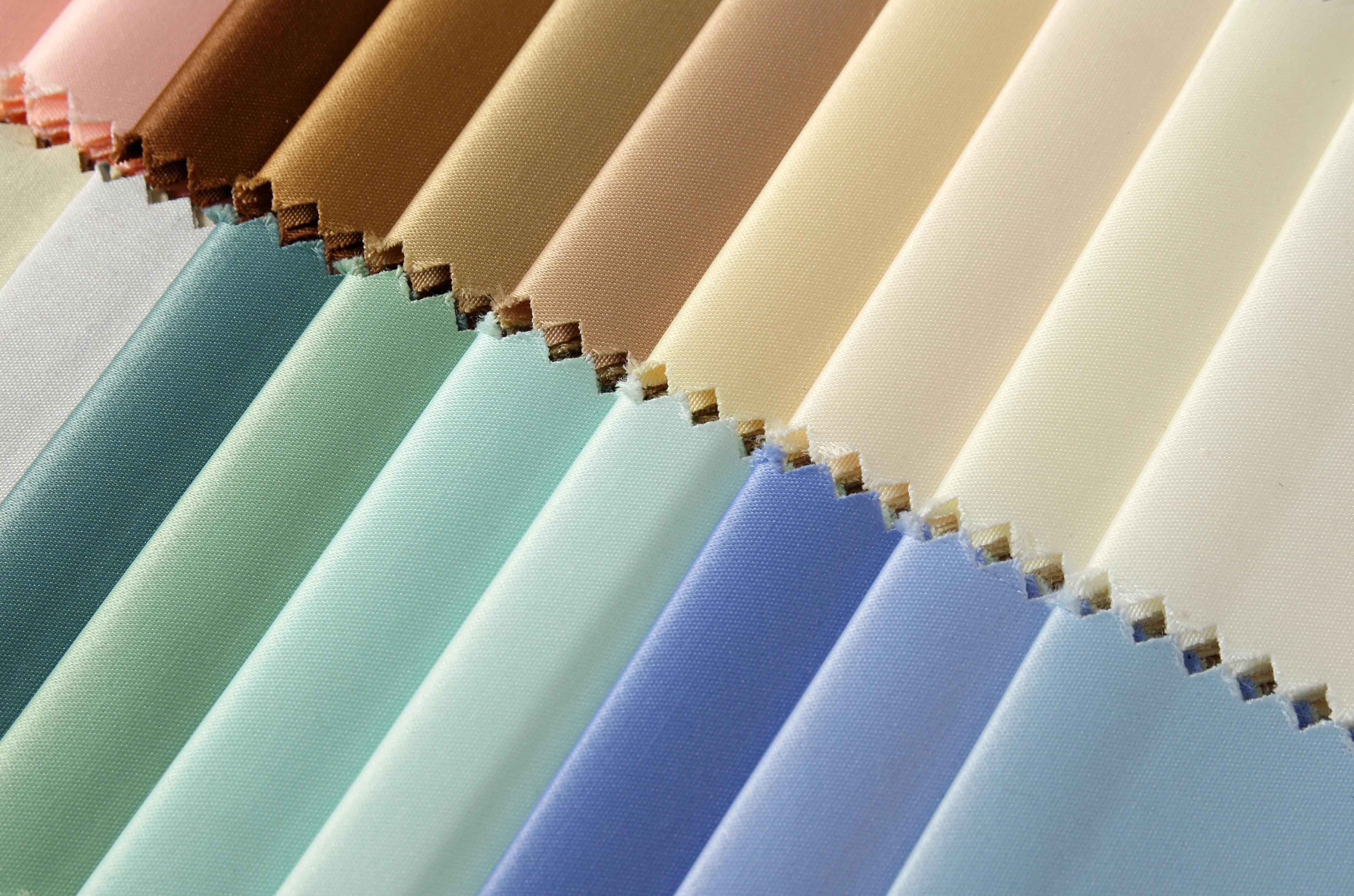 woman admiring roller blinds on a window from curtain and blinds co who sells blinds online in UAE